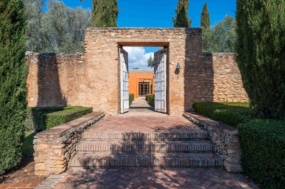 Cortijo entrance with wooden antique doors, Ronda